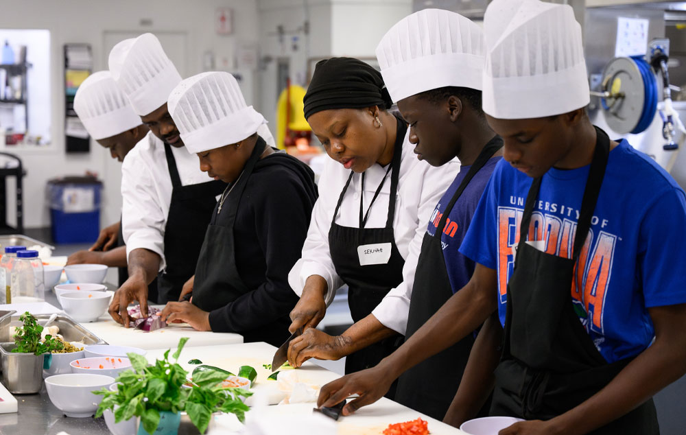 Youth from the AfricadianEmpowerment Academy prepare a meal in the Halifax Convention Centre kitchen